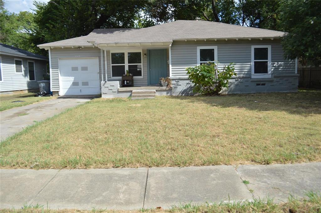 a front view of house with yard seating and green space