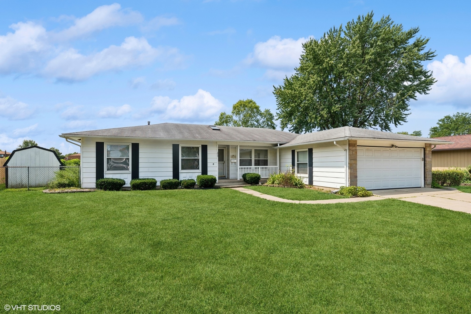 a front view of a house with a garden and porch