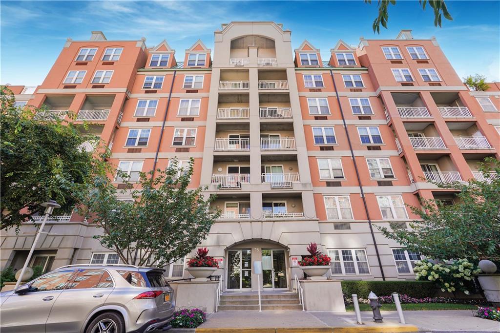 a front view of a residential apartment building with a yard