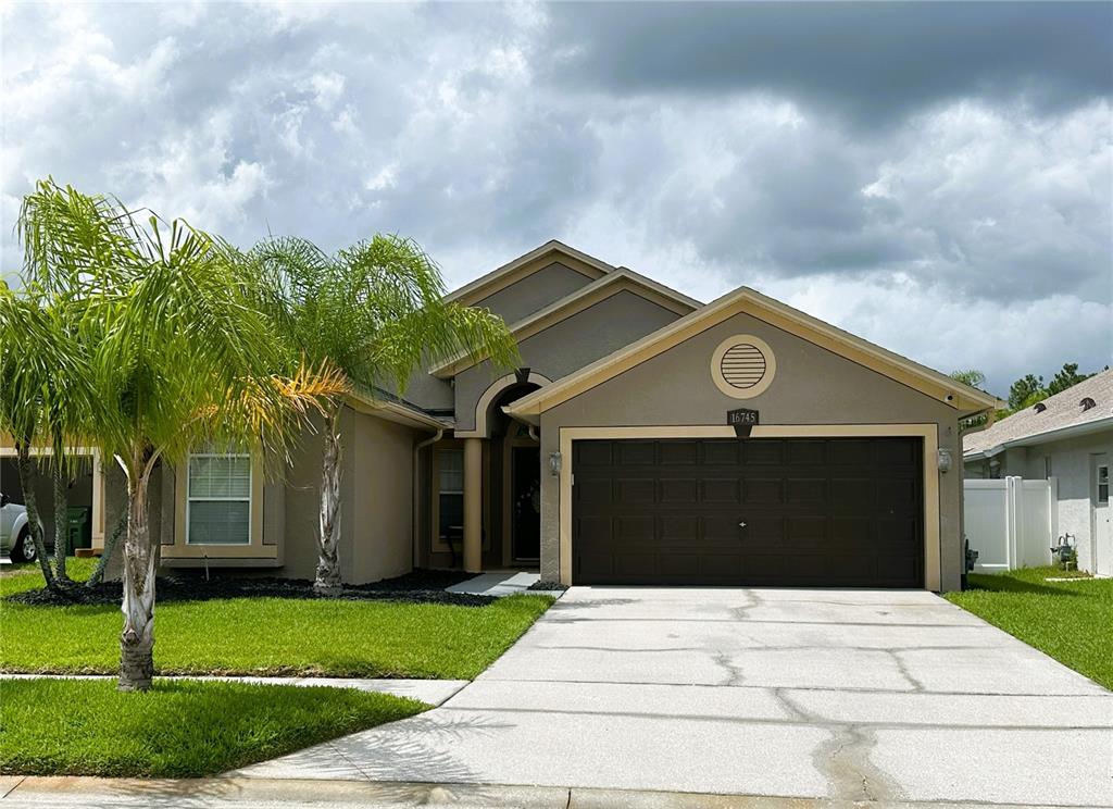 a front view of a house with a yard and garage