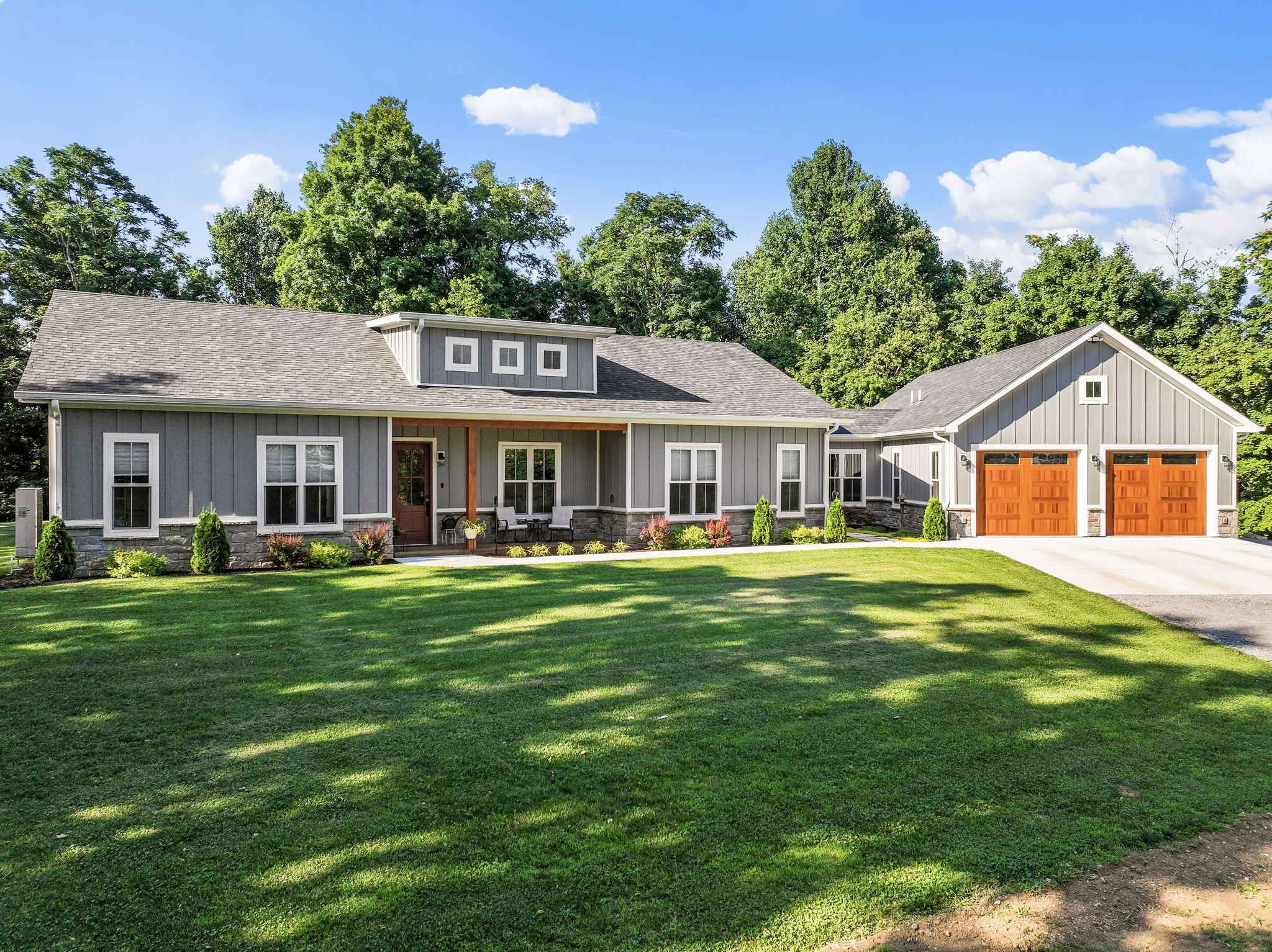 a front view of a house with a garden