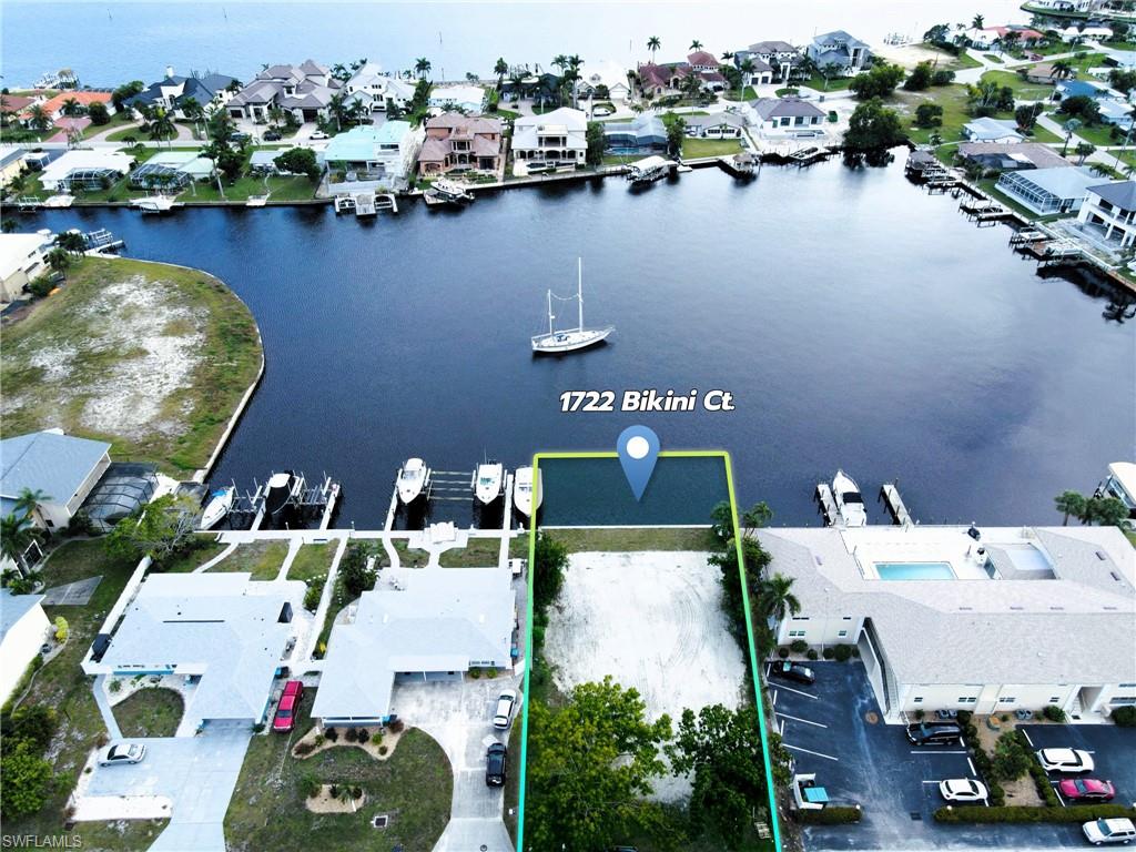 an aerial view of a house with swimming pool and outdoor seating