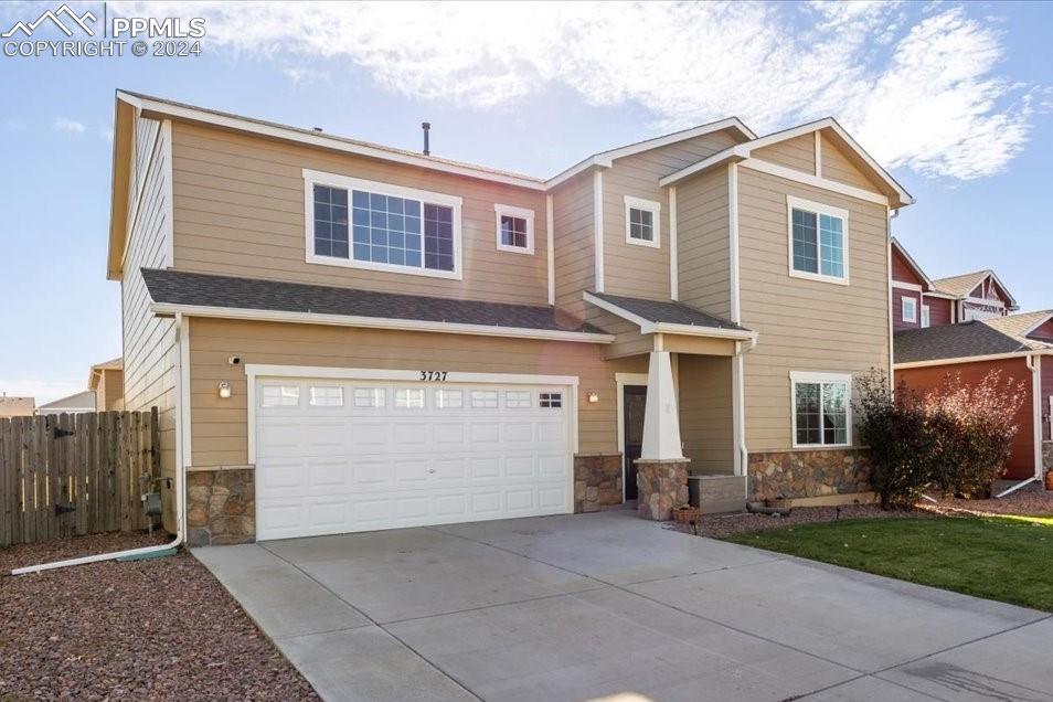 a front view of a house with a yard and garage