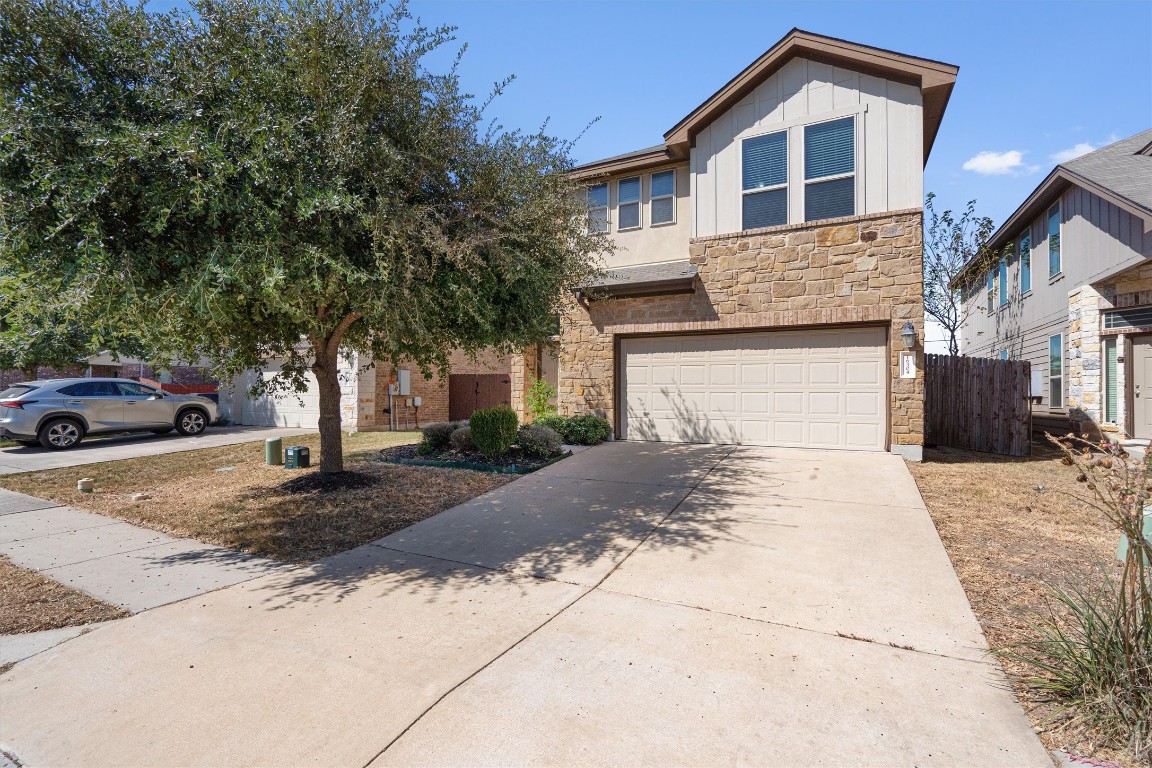 a front view of a house with a yard and garage