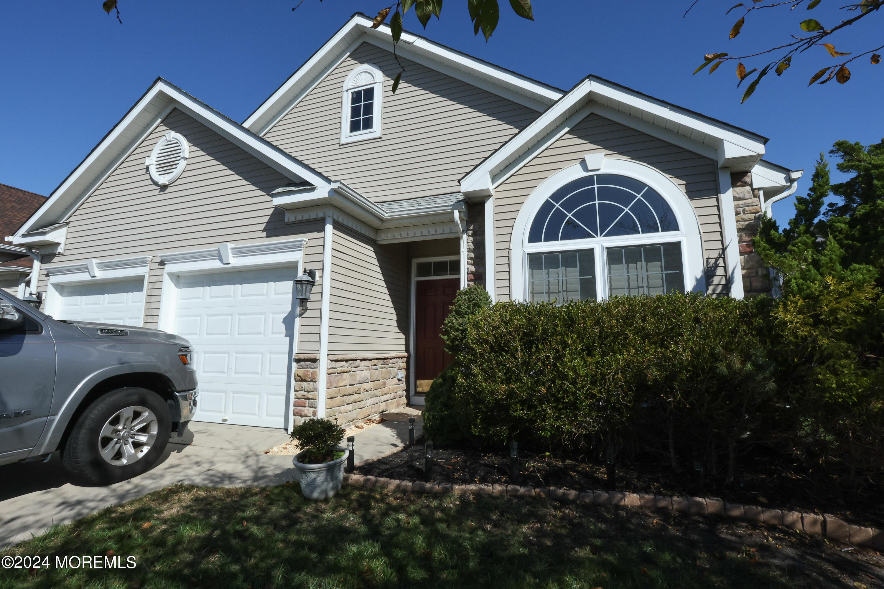 a front view of a house with a garden