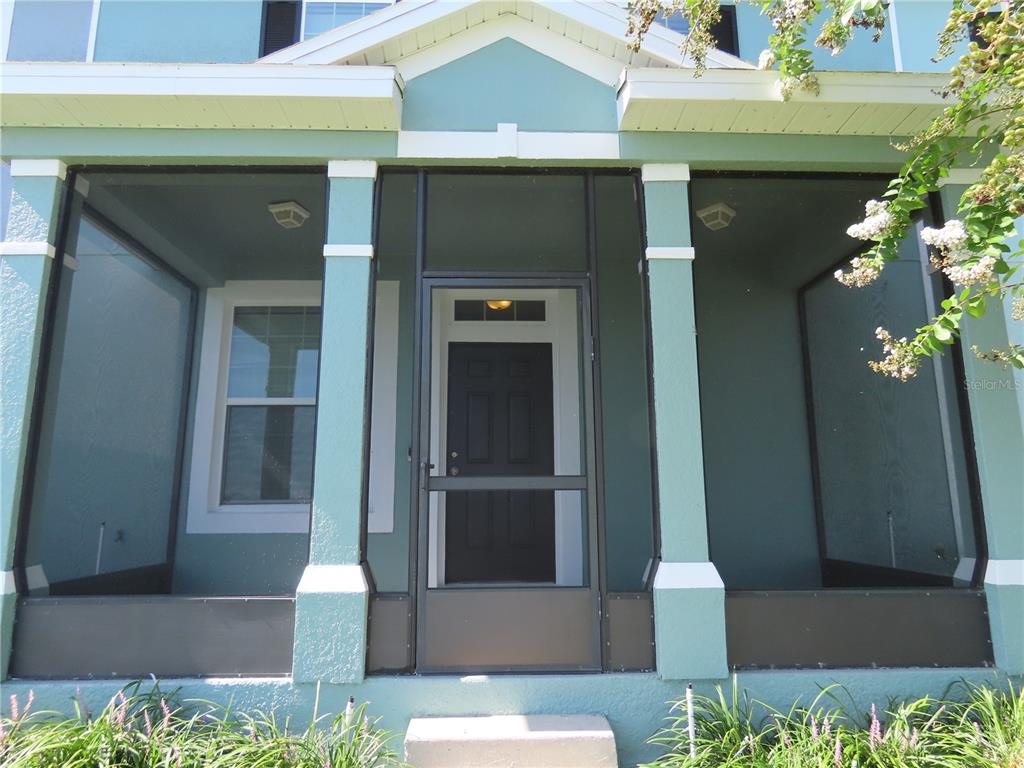 a front view of a house with a plants