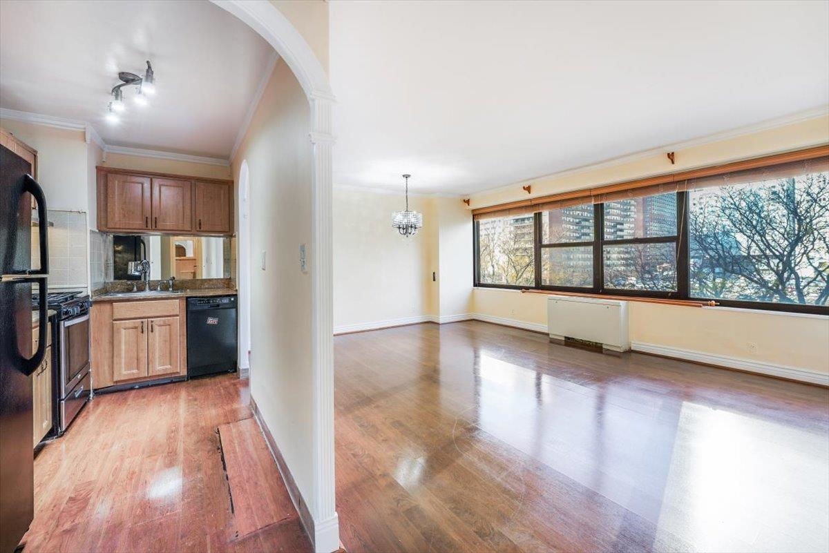 a view of a kitchen with a sink and wooden floor