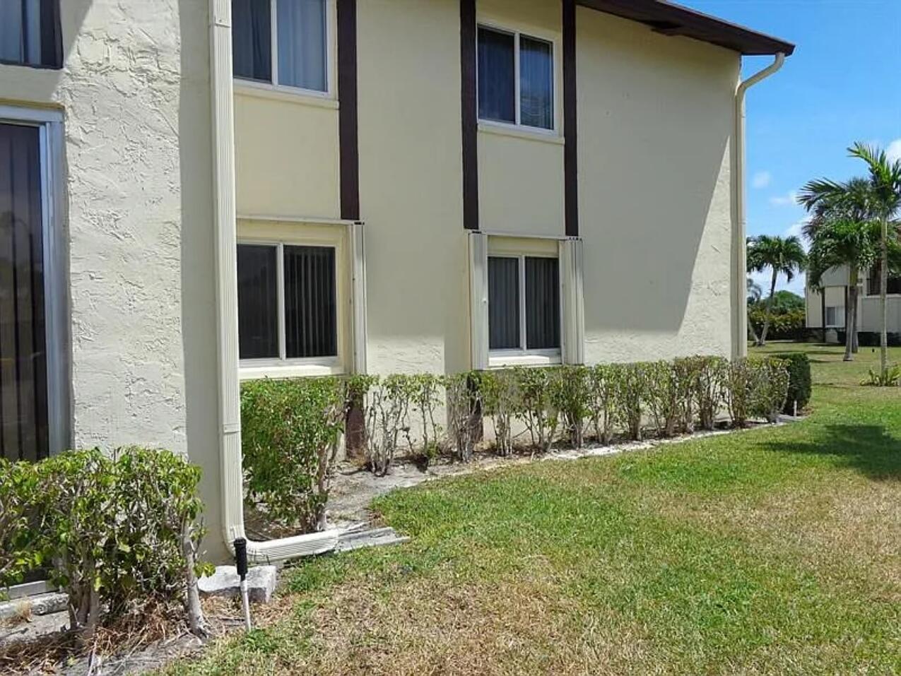 a view of a house with a yard and plants