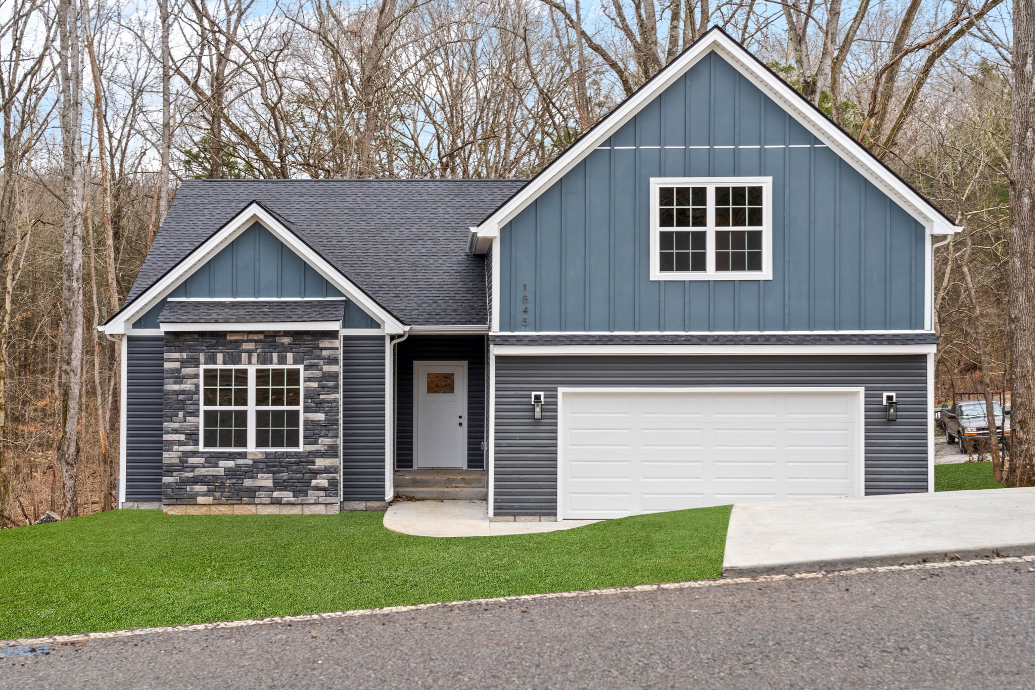 a front view of a house with a yard and garage