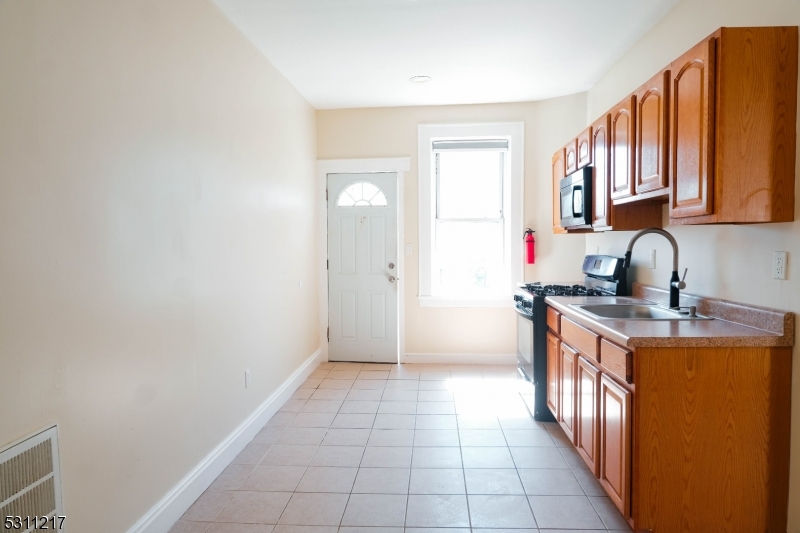 a kitchen with stainless steel appliances granite countertop a stove and a sink