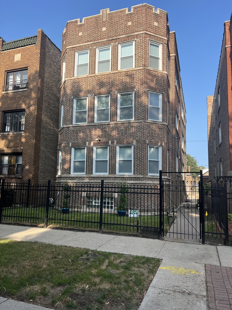 a view of a brick building next to a yard