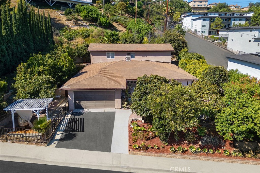 an aerial view of a house with garden space and street view