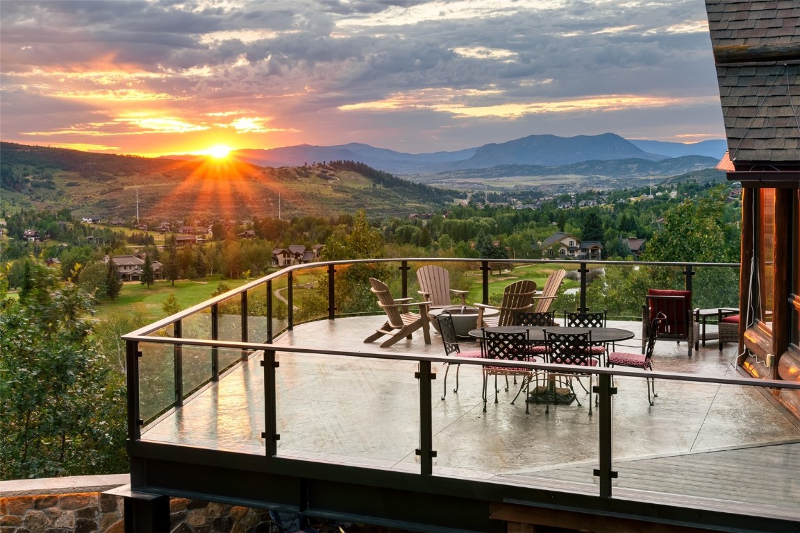 a view of a balcony with mountain view and wooden floor