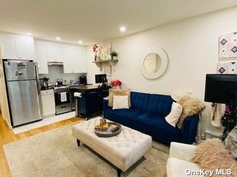 a living room with furniture and kitchen view