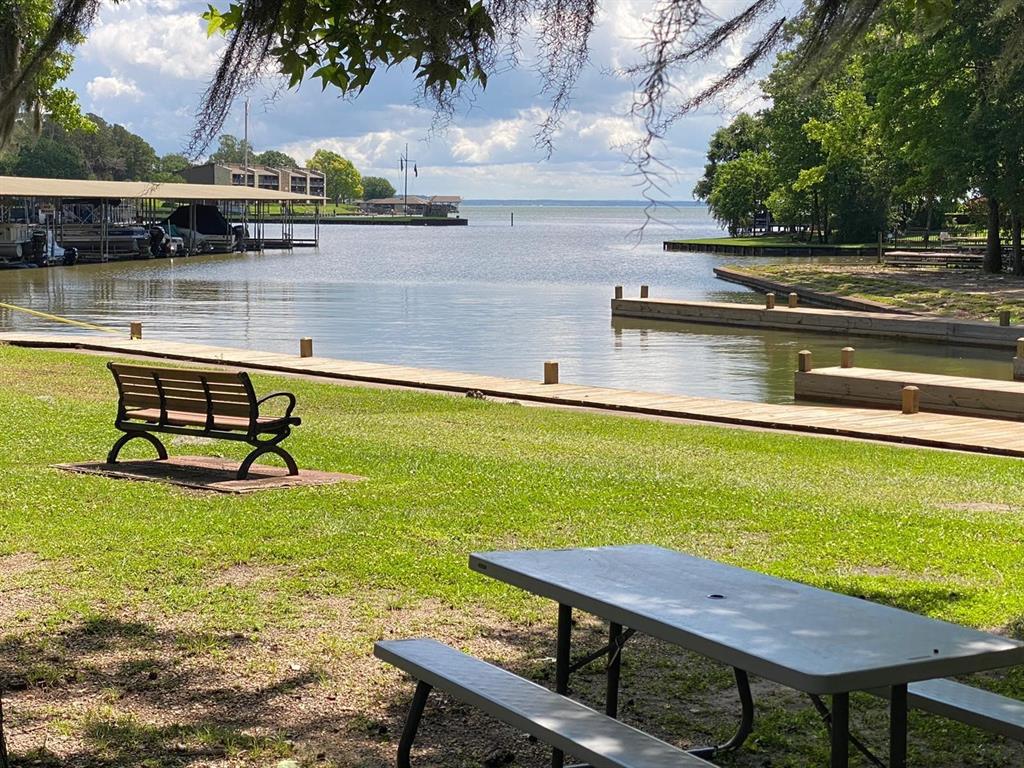 a view of a swimming pool with outdoor seating and lake view