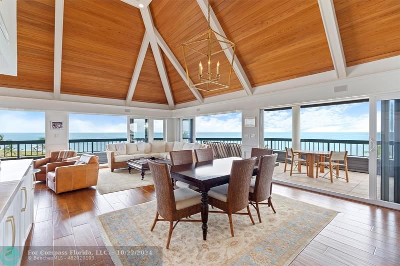 a dining room with furniture window and wooden floor