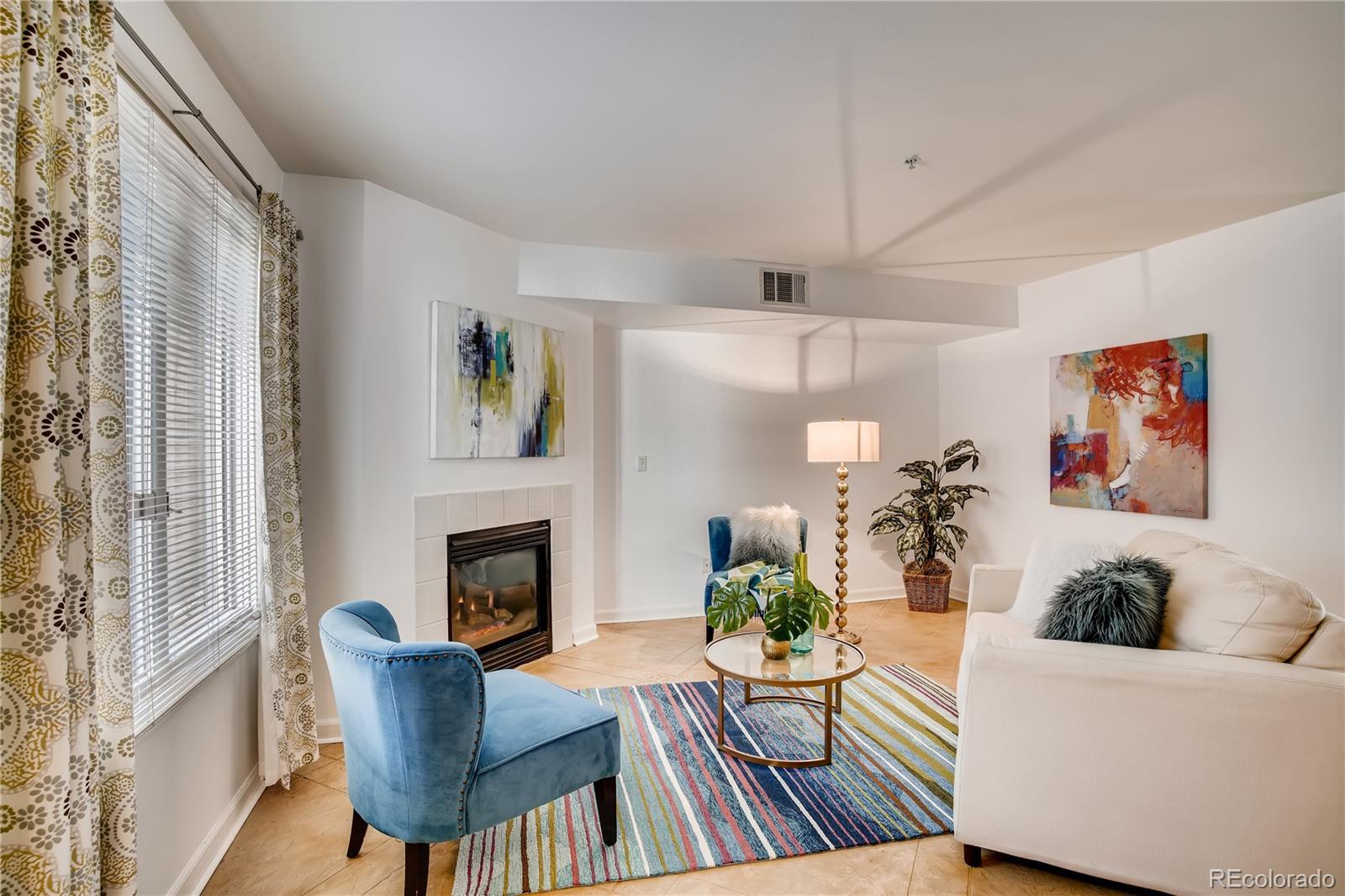 a living room with furniture fireplace and dining table