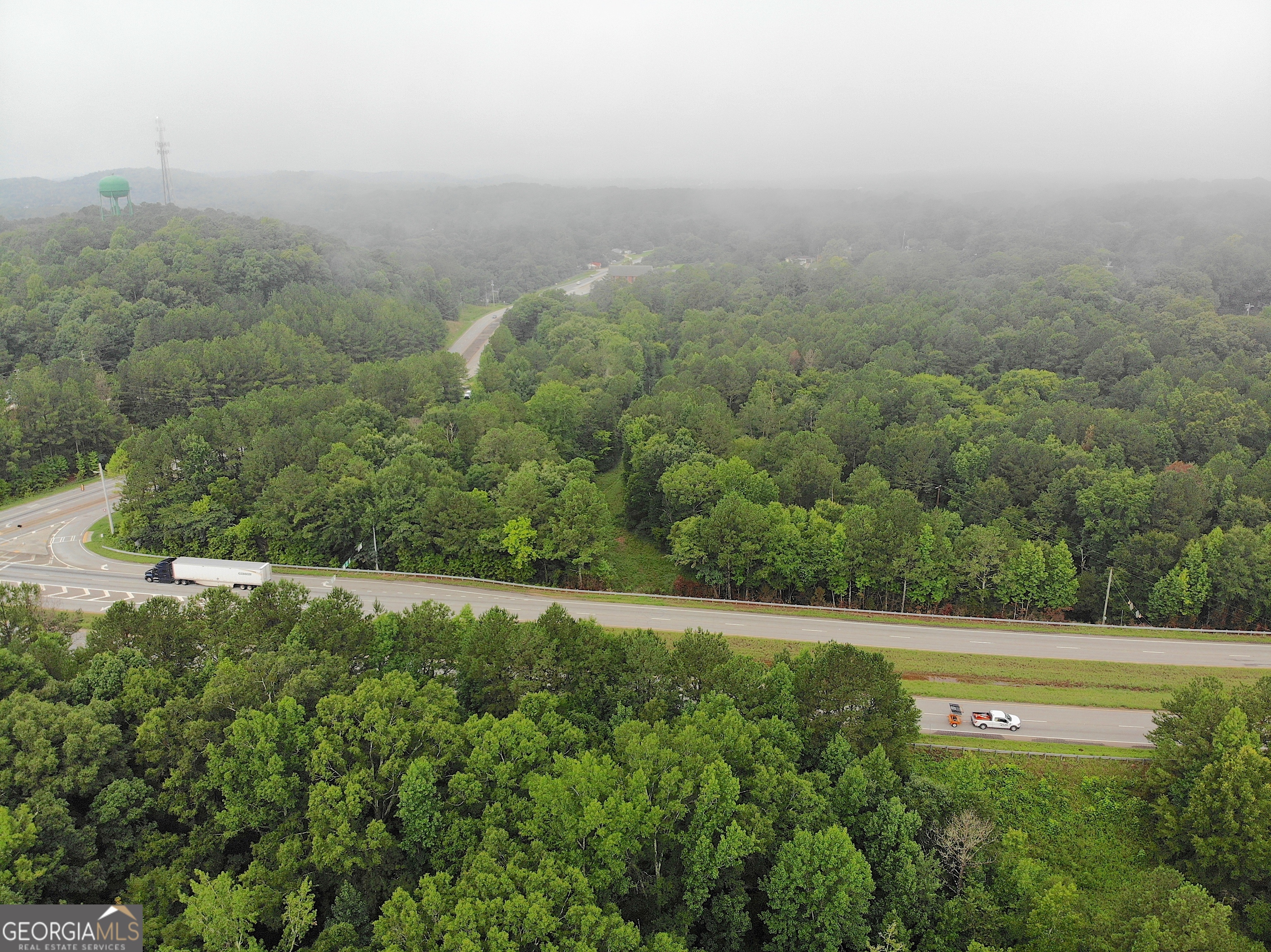 a view of a big yard with lots of green space