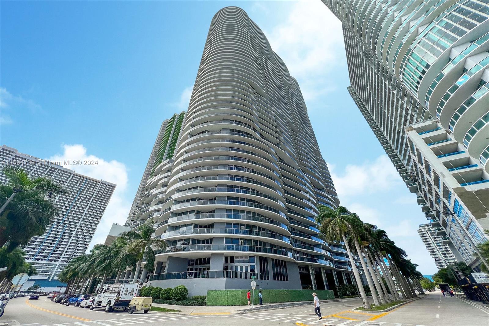 a view of a tall building next to a road