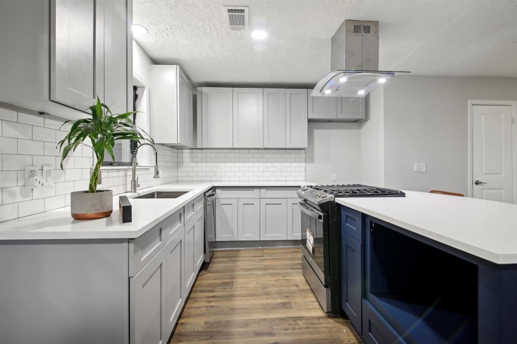 a kitchen with a sink and a stove top oven