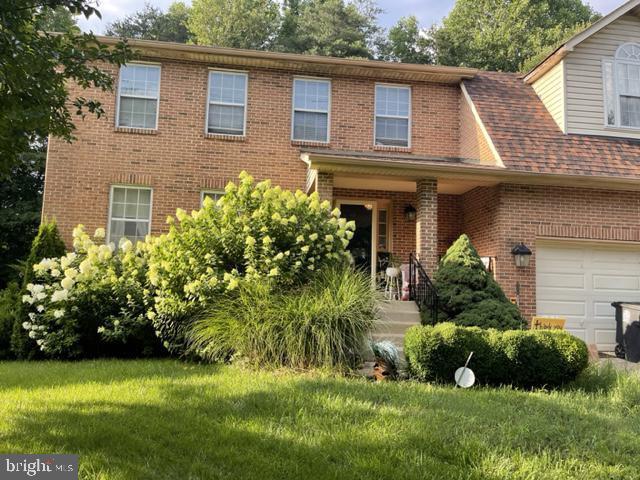 a view of a house with a yard and plants