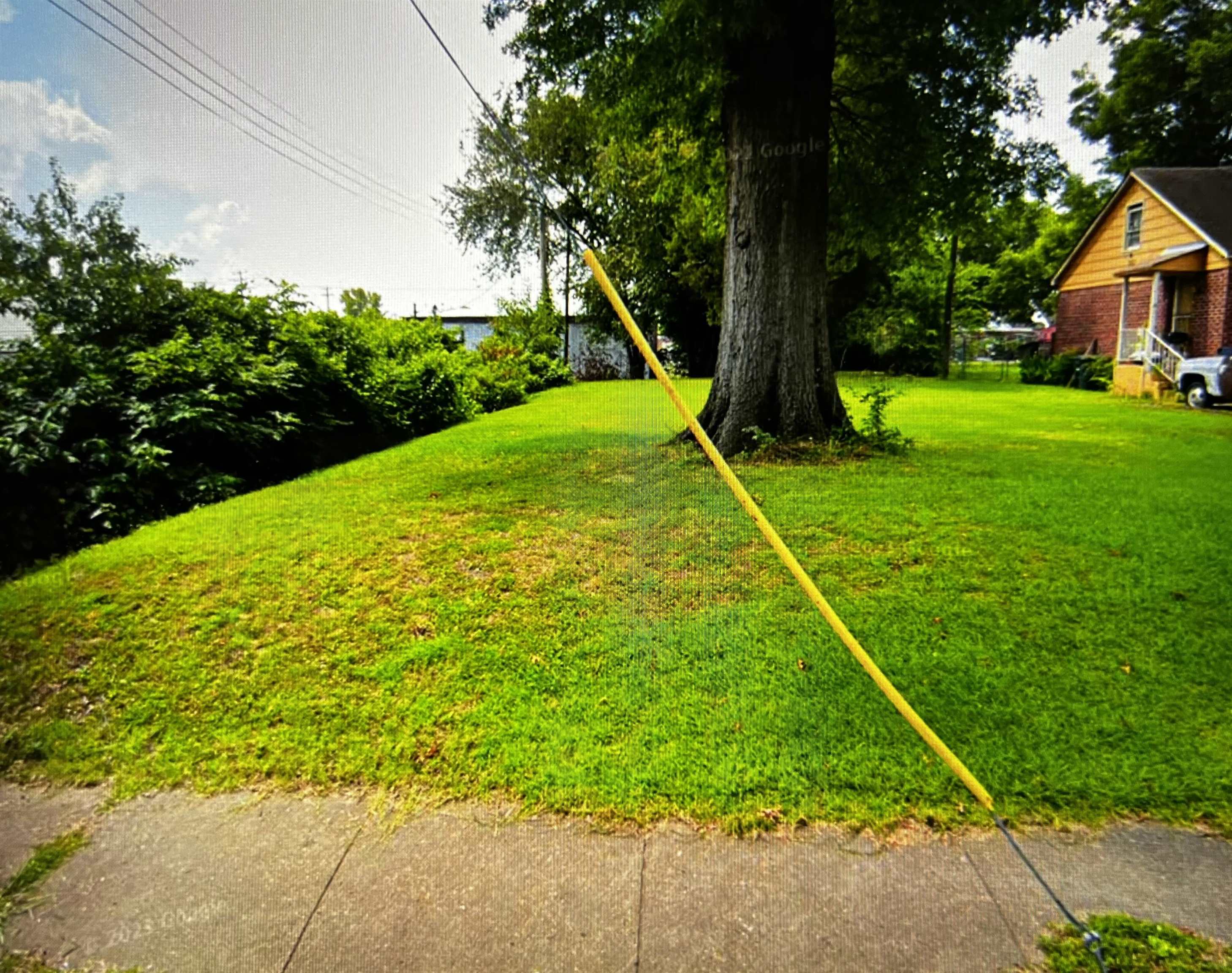 a view of backyard with swimming pool and green space