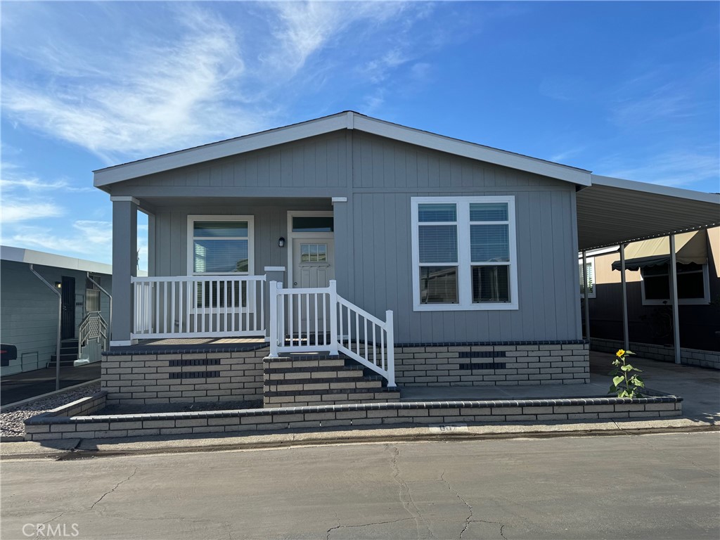 a view of a house with a small deck