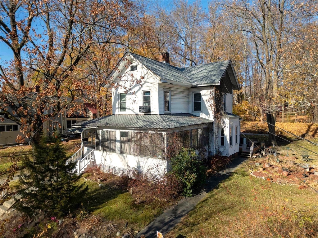 a view of a house with a yard covered with snow in the background