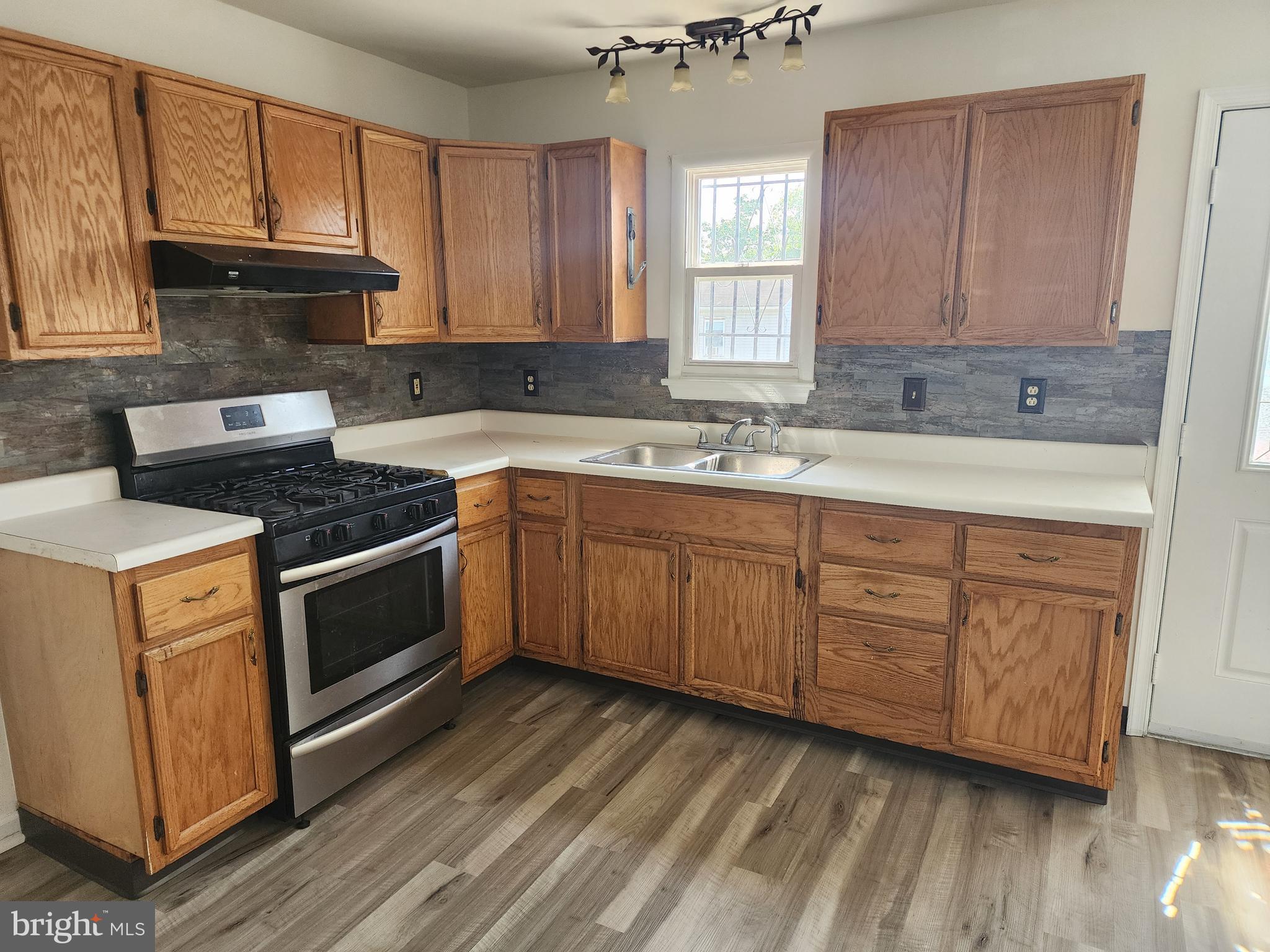 a kitchen with a sink stove and cabinets