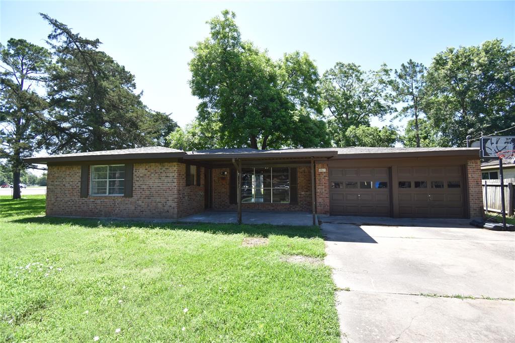 a front view of house with yard and trees