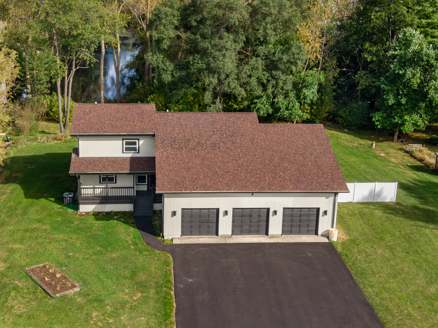 aerial view of a house with a yard table and chairs