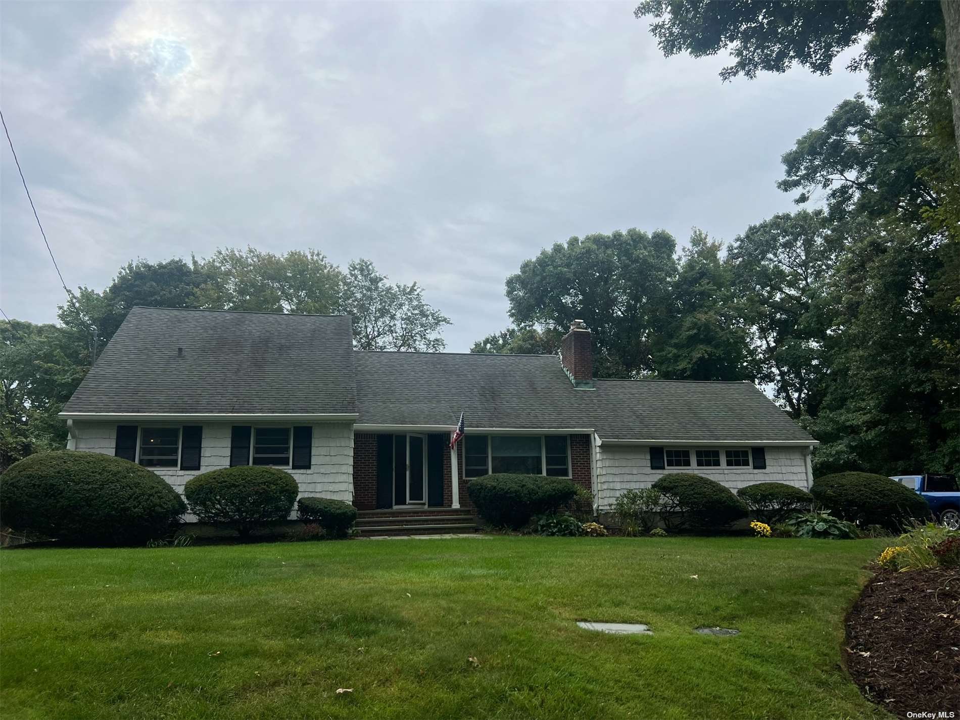 a front view of a house with a garden