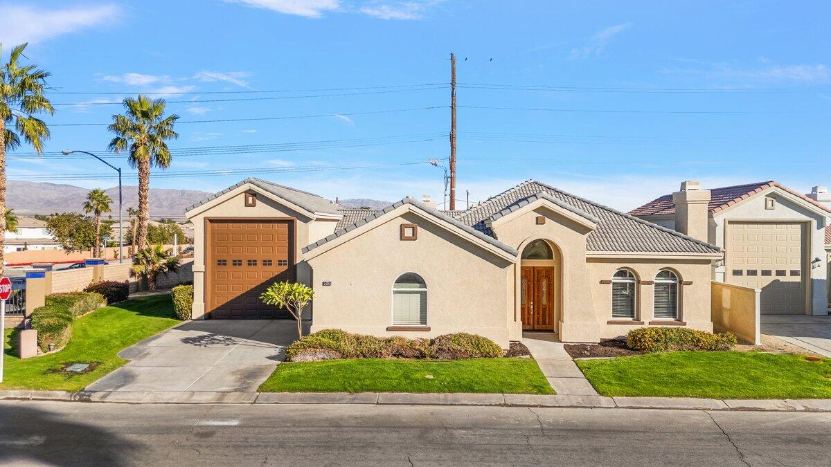 a front view of a house with a yard and garage