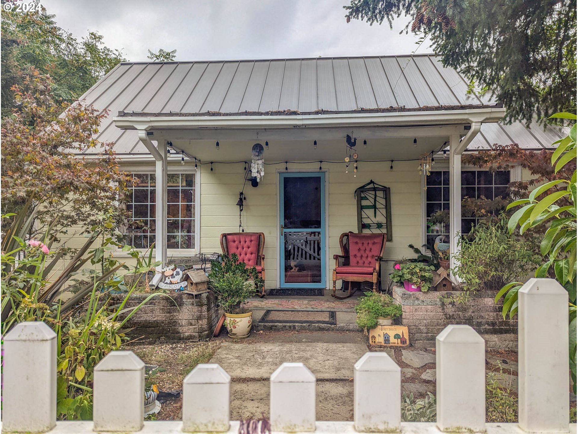 a front view of a house with outdoor seating