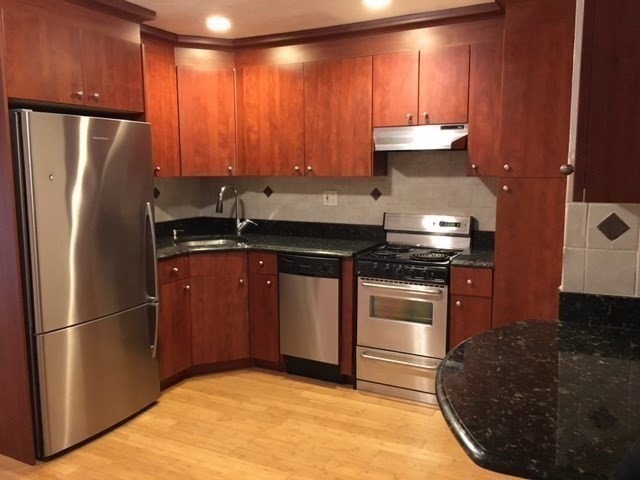 a kitchen with a refrigerator and a sink