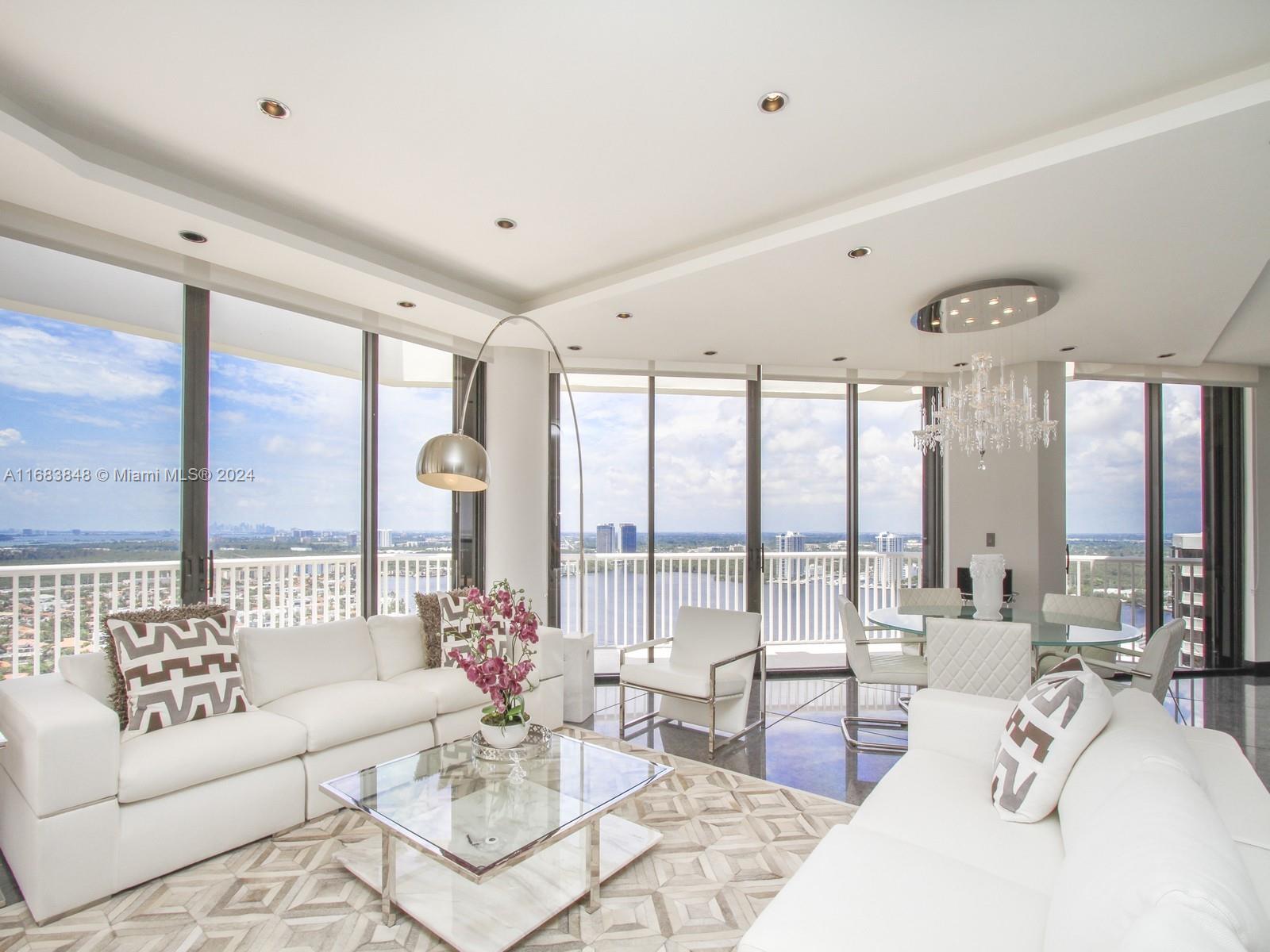 a living room with furniture and large windows