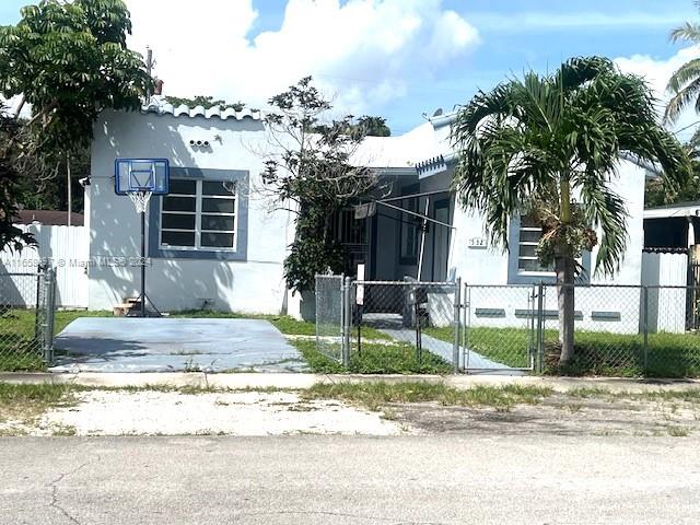 a front view of a house with garden and plants