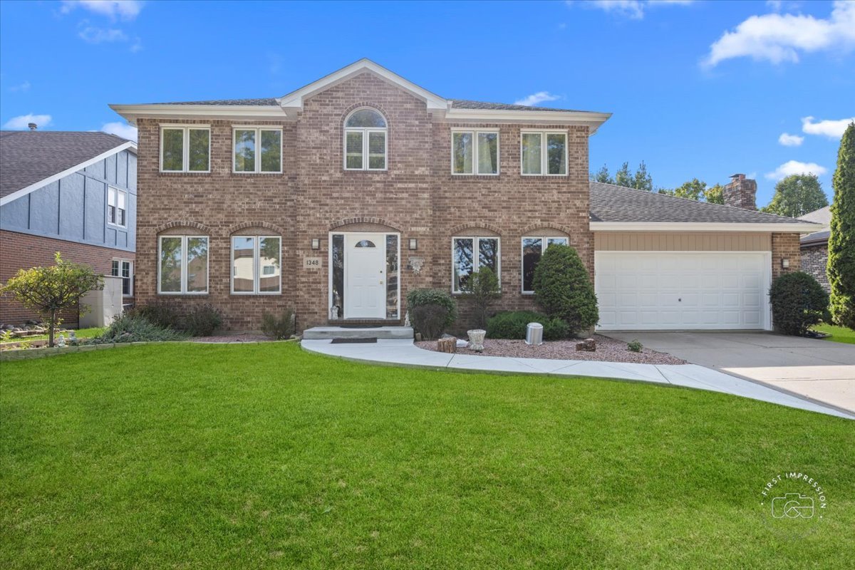 a front view of a house with a yard and garage