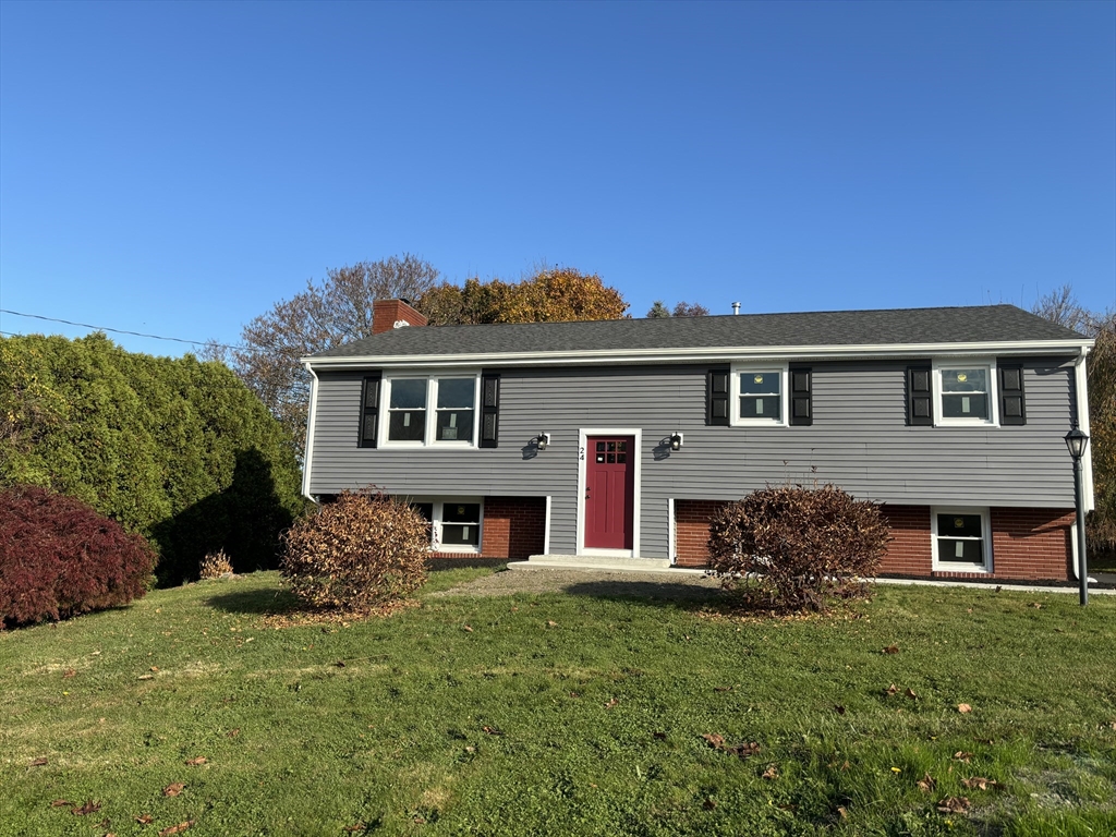 a front view of house with yard and green space