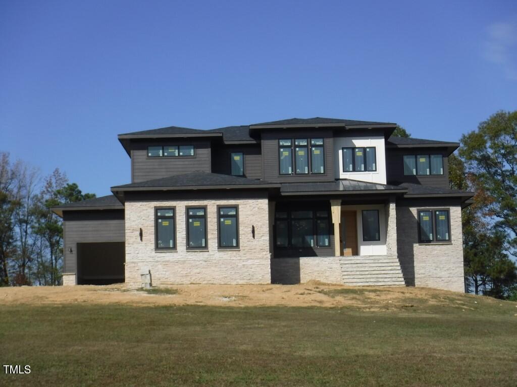 a front view of a house with a garden