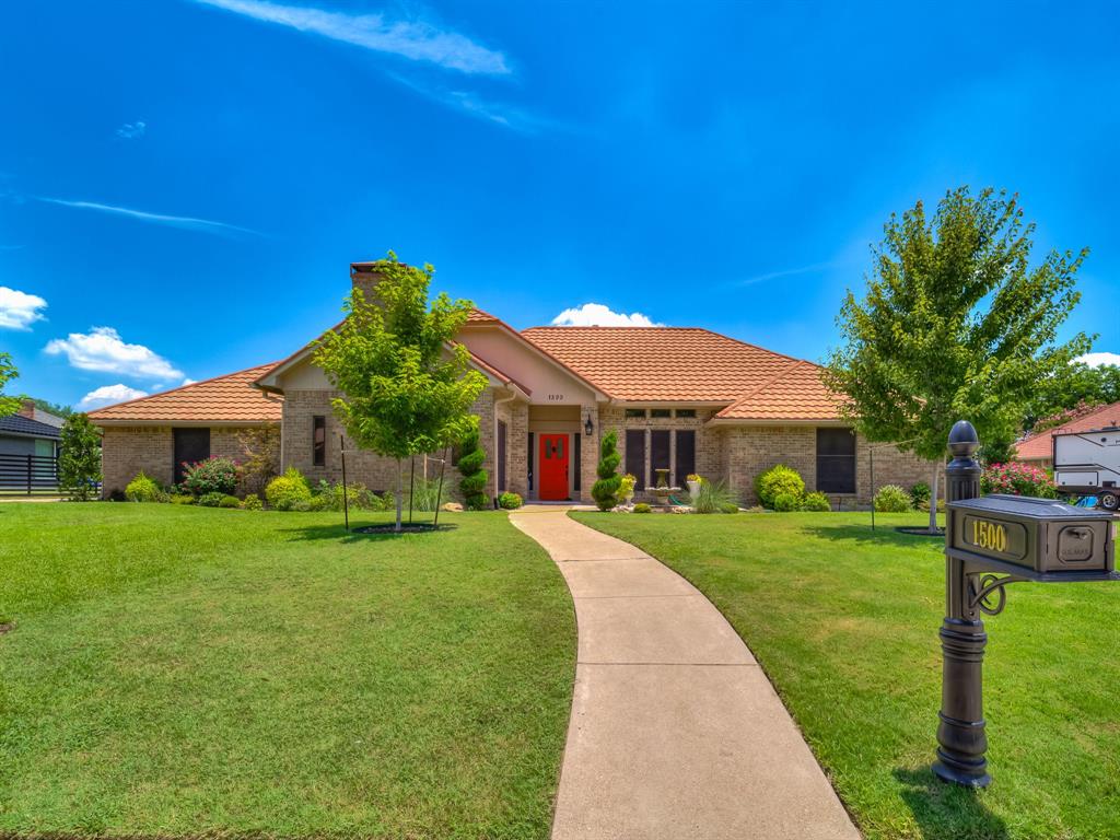 a front view of house with yard and green space