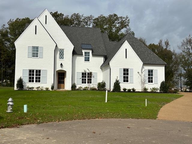 a view of a white house with a yard