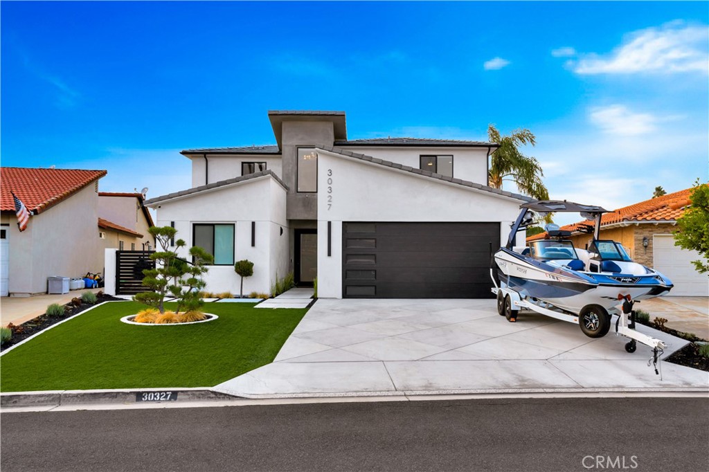 a house view with a sitting space fire pit and outdoor space