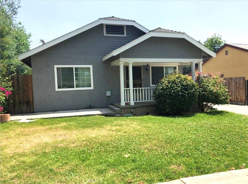 a front view of a house with yard and green space