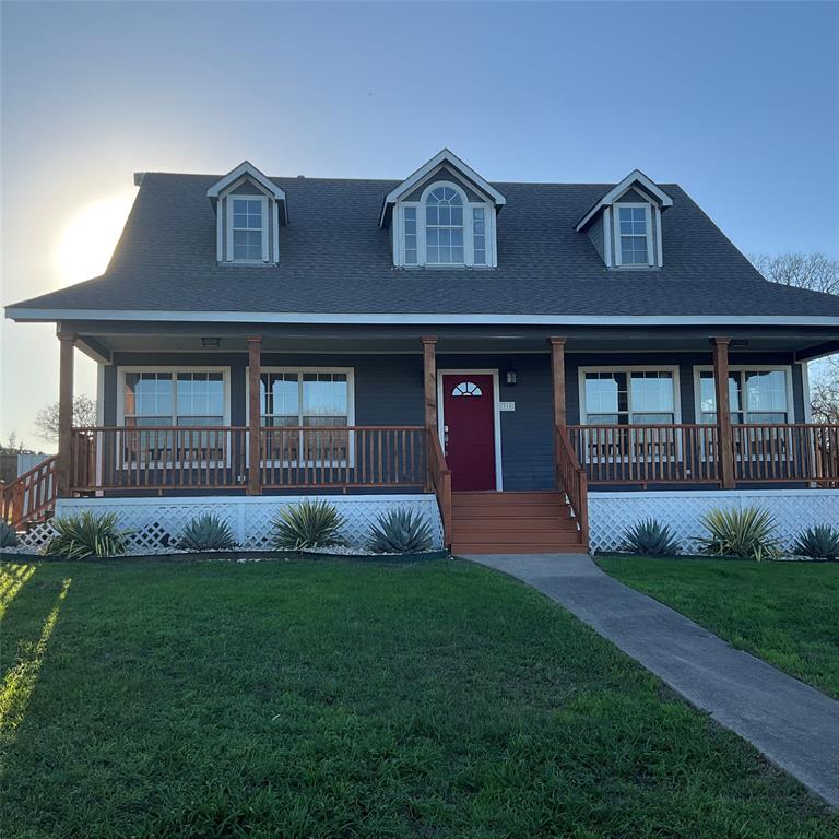 a front view of a house with garden and garage