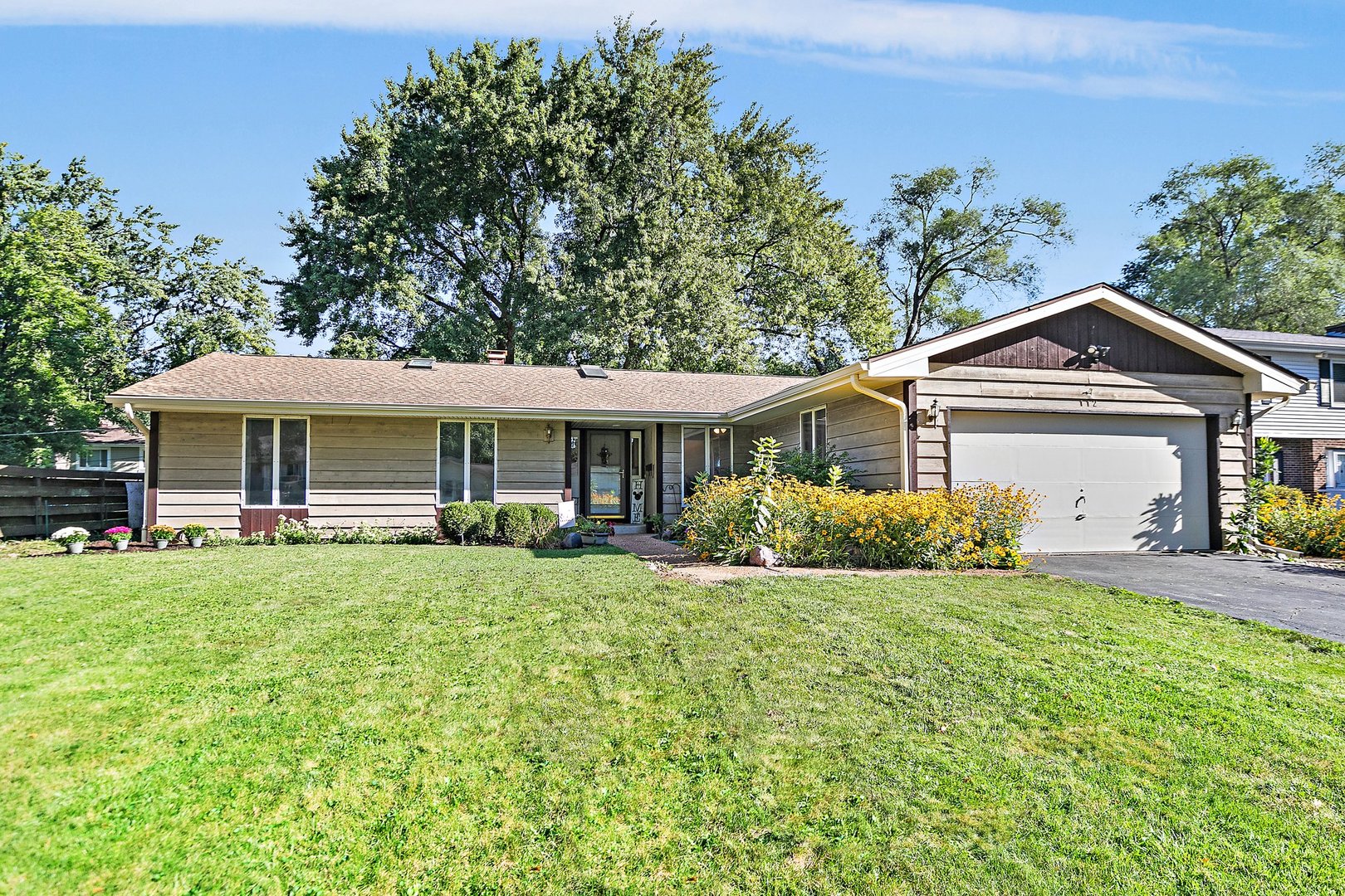 a front view of a house with a garden