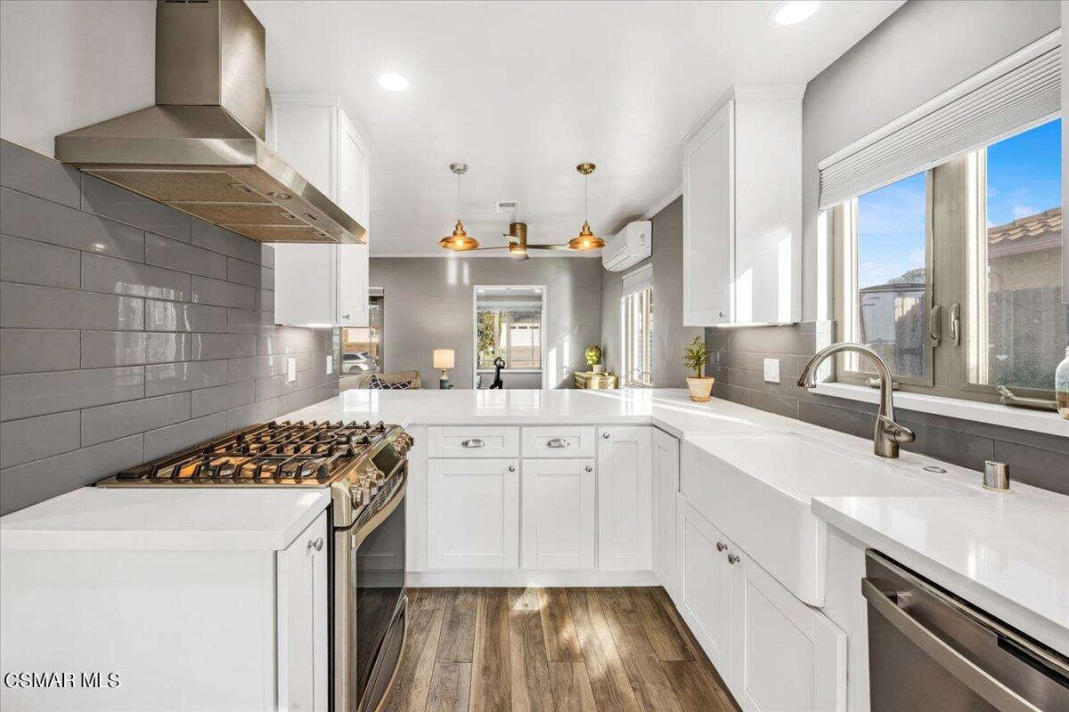 a kitchen with a sink stove and cabinets