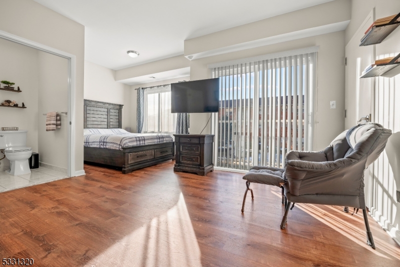 a bedroom with furniture and a flat screen tv