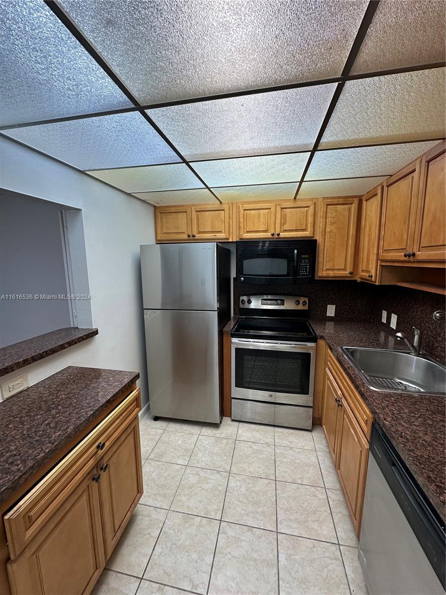 a kitchen with stainless steel appliances granite countertop a stove and a refrigerator