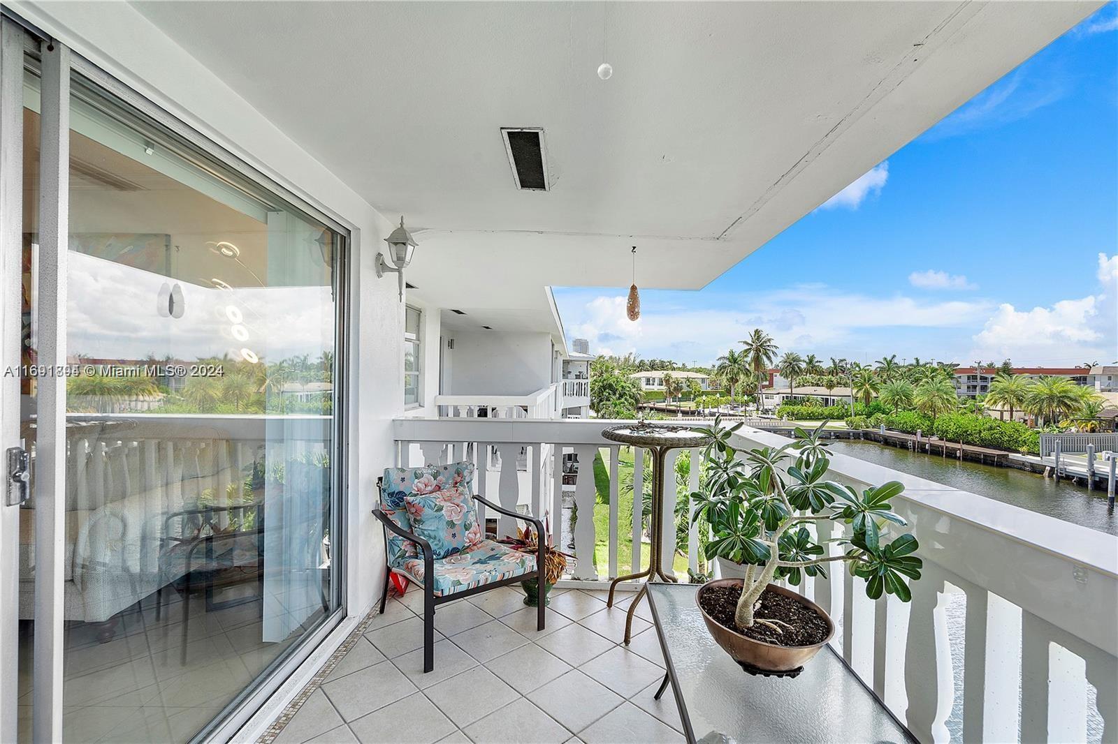 a balcony with furniture and a potted plant